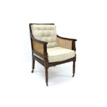 Good Regency mahogany bergère chair with carved back and sides, in reeded frame,