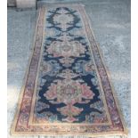 Persian tribal runner, indigo field centred by three pendant medallions,