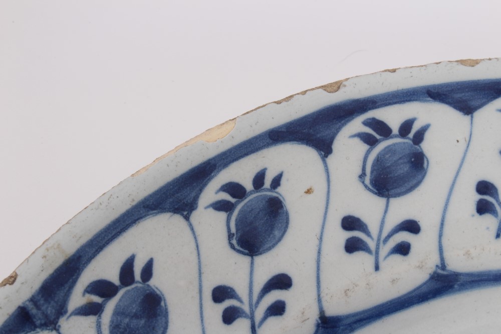 Mid-18th century Delft blue and white tin glazed charger with painted still life of flowers and - Image 5 of 6
