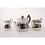 Edwardian silver Art Nouveau three piece tea set - comprising teapot of bulbous cauldron form,