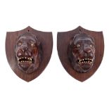 Pair of antique Anglo-Indian carved hardwood lion-head trophies,