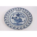 Mid-18th century Delft blue and white tin glazed charger with painted still life of flowers and