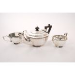 1920s silver three piece tea set - comprising teapot of cauldron form, with faceted decoration,