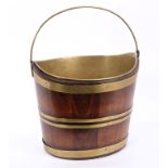 George III mahogany and brass bound peat bucket of typical coopered tapered form, with swing handle,