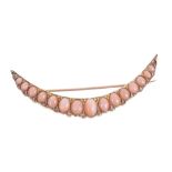 Victorian pink coral and diamond crescent brooch with fifteen graduated oval coral cabochons and