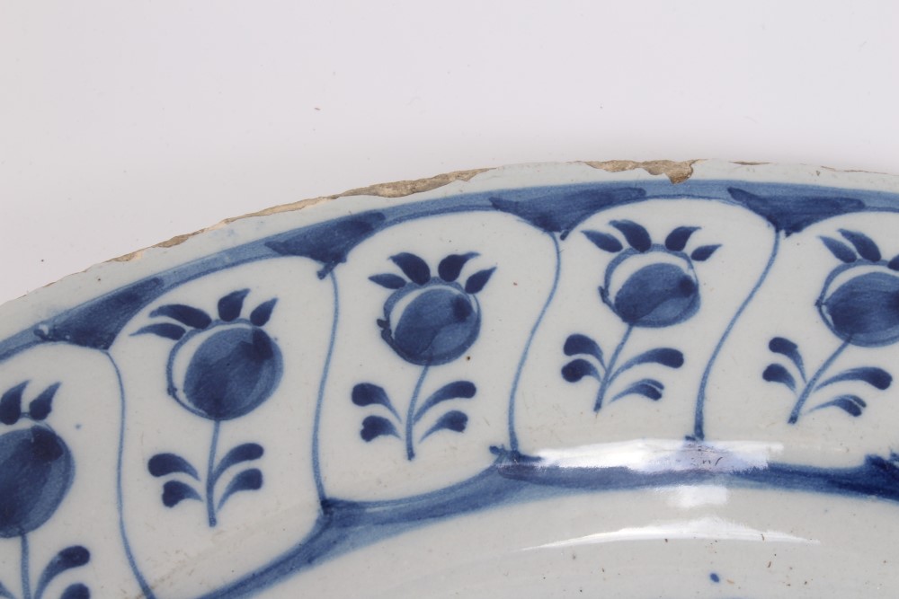 Mid-18th century Delft blue and white tin glazed charger with painted still life of flowers and - Image 3 of 6