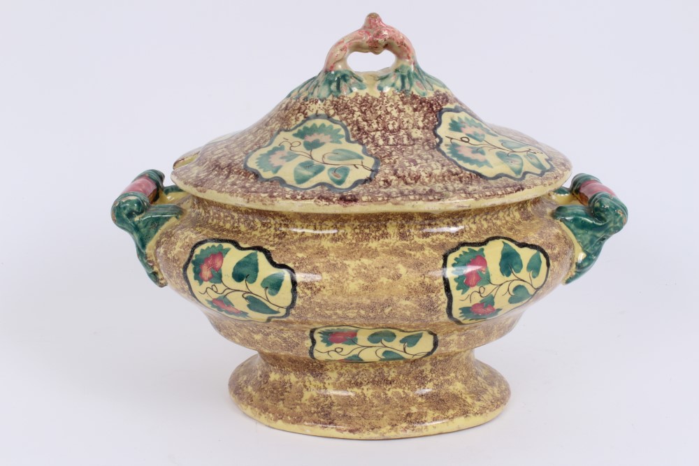 Early 19th century Continental faience oval tureen and cover with floral reserves on brown mottled