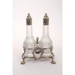 George II silver cruet frame with scroll handle and legs on shell feet,