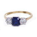 Sapphire and diamond three stone ring with a step cut sapphire measuring approximately 6.8mm x 5.