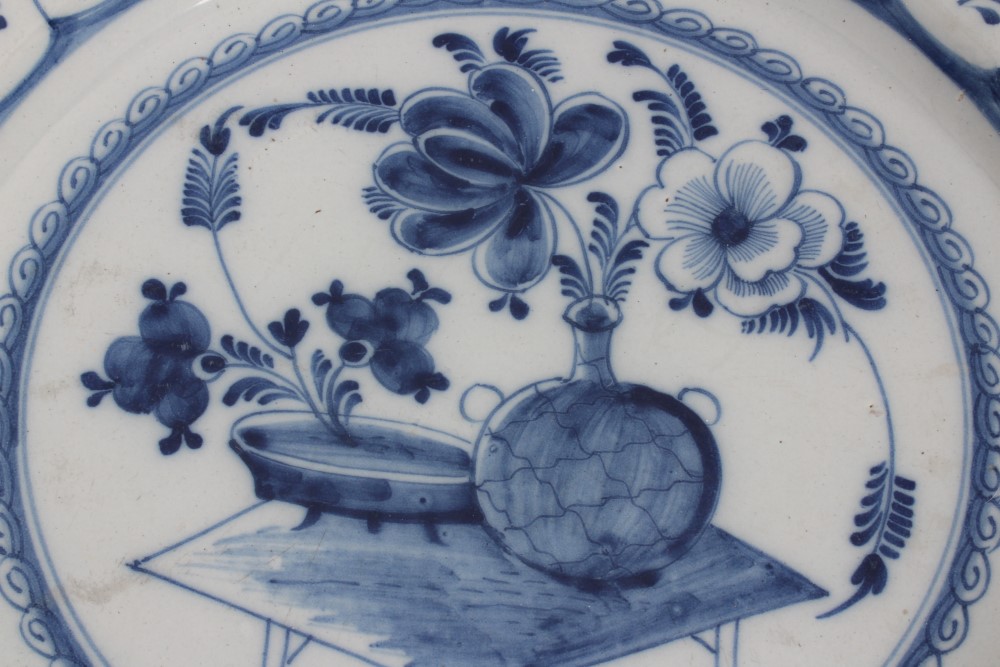 Mid-18th century Delft blue and white tin glazed charger with painted still life of flowers and - Image 2 of 6