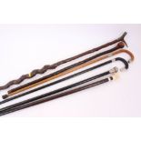 Three Victorian silver mounted walking sticks, ivory mounted stick,