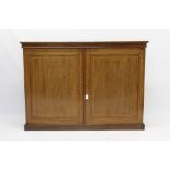 Edwardian mahogany and satinwood crossbanded enclosed dwarf bookcase of shallow form,