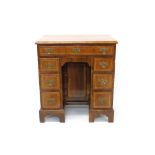 Early 18th century walnut crossbanded kneehole desk with seven drawers about the cupboard kneehole,