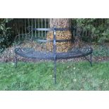 19th century black painted wrought iron tree bench - comprising semi-circular bench with scroll