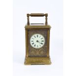 Late 19th century French carriage clock with circular enamel dial on gilt blind fretwork floral