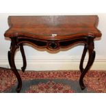 Late nineteenth century Continental walnut and ebonised tea table on carved cabriole legs,