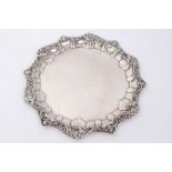 Late Victorian silver card tray with shell and foliate scroll border and presentation inscription,