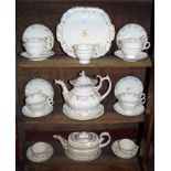 Early 19th century Derby teapot and cover on stand together with a pair of Derby tea cups and