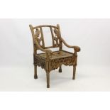Antique Chinese provincial hardwood chair with pierced back and scroll arms