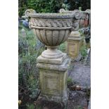 Set of ten classical-style concrete garden urns of squat lobed form with scroll handles, 46cm high,