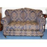 Pair of modern twin seater sofas with navy upholstery with repeat acanthus design,