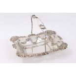 Late Victorian silver cake basket of rectangular pierced form with foliate embossed panels and