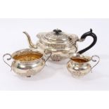 Edwardian silver three piece bachelors teaset with embossed foliate scroll decoration,