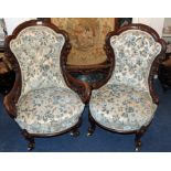 Pair of Victorian mahogany framed salon chairs with buttoned back upholstery on carved scroll legs