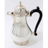 Georgian-style silver coffee pot of potbellied form with ebonised handle, (Birmingham 1969),