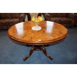 Victorian figured walnut oval loo table with quarter veneered tilt top on bulbous column and