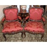 Pair of nineteenth century Continental open elbow chairs with carved walnut show-wood frames,