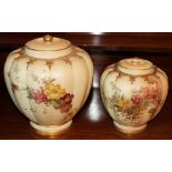 Two graduated Royal Worcester blush ivory vases and covers of melon form with floral painted