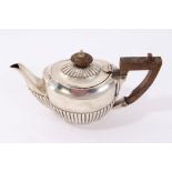 Early twentieth century silver bachelor's teapot of semi-fluted form, with wooden finial and handle,