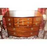 Early twentieth century mahogany bow front chest with an arrangement of nine drawers,