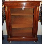 Late Victorian rosewood pier cabinet enclosed by a glazed door on spool feet,
