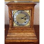 Edwardian oak cased mantel clock of square form with brass dial and twin chain movement striking on