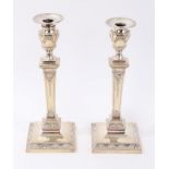 Pair of Victorian silver candlesticks of neoclassical form with beaded and swag borders,