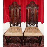 Pair of nineteenth century Carolean-style walnut high back chairs with carved crestings and