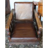 Pair of 1920s oak recliner chairs with slat sides,