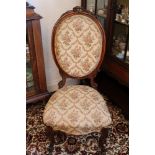 Victorian carved walnut side chair with carved top rail and oval pad back and seat on cabriole legs