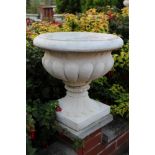 Set of six classical-style concrete garden urns of squat campana form on integral square base,