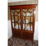 Edwardian inlaid mahogany display cabinet with shelved interior enclosed by twin astragal glazed