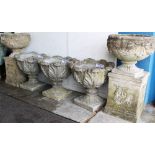 Set of four classical-style concrete garden urns of acanthus moulded form, on integral square base,