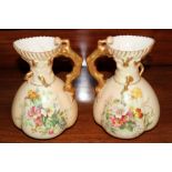 Pair of Royal Worcester blush ivory jugs of squat form with floral sprays and branch-work handles,