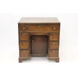 George III oak kneehole dressing table with seven drawers about the cupboard kneehole,