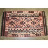 Antique Kelim rug, repeat lozenge motif in geometric borders and printed red, brown and blue tones,