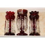 Pair of Victorian cranberry glass lustres with applied white enamel ornament, 36cm high,