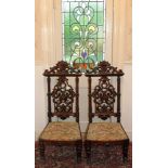 Pair of William IV rosewood hall chairs with pierced carved and scroll backs with tapestry seats on