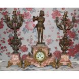 Early twentieth century French variegated rouge marble and gilt spelter clock garniture with figure