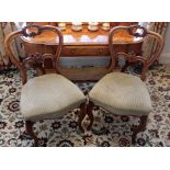 Set of four Victorian walnut dining chairs with green upholstered seats, on slender cabriole legs,